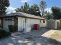 Home exterior showcasing a shed and generator at 2494 County Road 447, Lake Panasoffkee, FL 33538