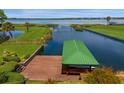 Private boat dock with covered boathouse on a tranquil lake at 17601 Sawgrass Run, Tavares, FL 32778