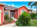 Front entrance with decorative screen door and fountain at 25611 Maurepas Ln, Leesburg, FL 34748