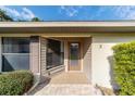 Inviting front entrance with a tiled walkway and landscaping at 3 Fir Trl, Ocala, FL 34472