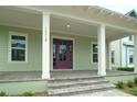Charming front porch with purple door and brick steps at 9934 Fiddley Aly, Orlando, FL 32827