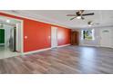 Bright living room featuring wood-look vinyl flooring and an accent wall at 2030 Leisure Dr, Winter Haven, FL 33881