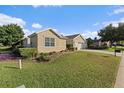 House with a well-manicured lawn and mature trees around at 13495 Se 93Rd Court Rd, Summerfield, FL 34491