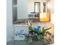 Entryway with a welcome sign, flowers, and a mirror reflecting the interior at 6152 Topsail Rd, Lady Lake, FL 32159