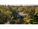 Single-story home surrounded by trees and lawn at 3064 Windham Dr, Eustis, FL 32726