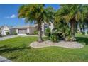 House exterior with palm trees and landscaped yard at 5429 Sea Leopard St, Tavares, FL 32778