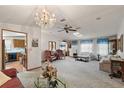 Bright living room with ample seating and a chandelier at 25504 Belle Alliance, Leesburg, FL 34748