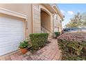 Townhome entry with brick pavers, shrubs, and a stairway leading to the front door at 5279 Bowline Ct, Oxford, FL 34484