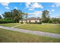 Single-story house with a red door and a well-manicured lawn at 2101 Sw 3Rd St, Ocala, FL 34471