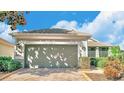 One story house with a two car garage and a landscaped yard at 119 Crescent Moon Dr, Groveland, FL 34736
