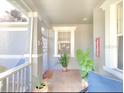 Inviting front porch with tile flooring and potted plants at 119 Crescent Moon Dr, Groveland, FL 34736