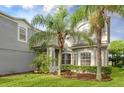 Two-story house with gray siding, lush landscaping, and a charming facade at 13412 Fox Glove St, Winter Garden, FL 34787