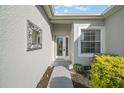 Front entry with decorative mirror and walkway to the door at 24124 Robinwood St, Leesburg, FL 34748