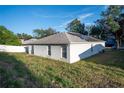Single story house with solar panels and grassy backyard at 1836 Ridge Valley St, Clermont, FL 34711