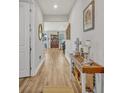 Bright entryway with hardwood floors and decorative console table at 2298 Raven Ridge Rd, Minneola, FL 34715