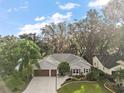Single-Gathering home with a three-car garage and landscaped yard at 3721 Plantation Blvd, Leesburg, FL 34748
