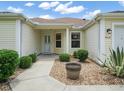 Front entrance of charming single-story house at 1514 Fenimore Ln, The Villages, FL 32162