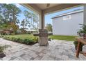 Outdoor patio with built-in grill and pavers at 34932 Golden Tree Dr, Leesburg, FL 34788
