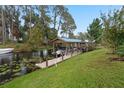 Covered boat dock with lift and waterfront access at 34932 Golden Tree Dr, Leesburg, FL 34788
