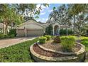 Two-story home with a three-car garage and manicured landscaping at 3646 Westover Cir, Leesburg, FL 34748