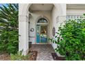 Inviting front entry with a blue door and lush landscaping at 3646 Westover Cir, Leesburg, FL 34748