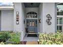 Inviting front entry with gray door and decorative accents at 1720 Park Forest Blvd, Mount Dora, FL 32757