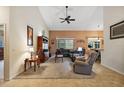 Spacious living room with vaulted ceiling, sectional sofa, and built-in entertainment center at 1720 Park Forest Blvd, Mount Dora, FL 32757
