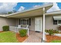 Front entrance with covered porch and brick walkway at 17571 Se 105Th Ter, Summerfield, FL 34491