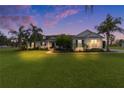 House exterior view at dusk, showcasing the home's curb appeal at 4100 County Road 121D, Wildwood, FL 34785