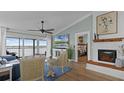 Bright living room with fireplace and water views at 450 Bouchelle Dr # 301, New Smyrna Beach, FL 32169