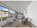 Spacious screened-in porch with comfortable seating area at 813 Royal Palm Ave, The Villages, FL 32159