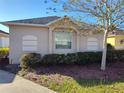 Tan single-story house with a manicured front yard at 928 Nuthatch Ave, The Villages, FL 32163