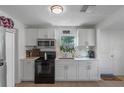 Bright kitchen with white cabinets, new appliances, and quartz countertops at 1109 S Smith Ave, Lakeland, FL 33815