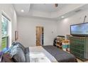 Main bedroom with a large bed, TV, and access to the bathroom at 1109 S Smith Ave, Lakeland, FL 33815
