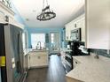 Bright kitchen featuring stainless steel appliances and an island at 11218 Fountain Lake Blvd, Leesburg, FL 34788