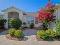 Landscaped front yard with a brick walkway at 21732 King Henry Ave, Leesburg, FL 34748