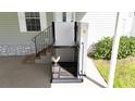 Close-up of a wheelchair lift providing home access at 227 Pinewood Dr, Eustis, FL 32726