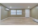 Bright living room with light wood flooring and neutral walls, showcasing a view of the front door at 2602 Cr 422, Lake Panasoffkee, FL 33538