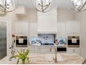 Gourmet kitchen with white cabinetry, granite counters, and high-end appliances at 39851 & 39855 Darlington Ave, Lady Lake, FL 32159