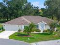 Single-story home with two-car garage and landscaped yard at 5416 Essex Ct, Leesburg, FL 34748