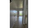 Bright hallway with tile floors and doors leading to other rooms at 652 Chelsea Dr, Davenport, FL 33897