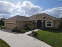 One-story home with a two-car garage and landscaped yard at 1010 Nantucket Sound, Mount Dora, FL 32757