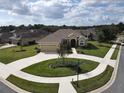 One-story home with a two-car garage and circular driveway at 1010 Nantucket Sound, Mount Dora, FL 32757