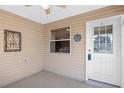 Covered porch with white door and window overlooking backyard at 17478 Se 77Th Sycamore Ave, The Villages, FL 32162