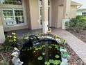 Koi pond with waterfall in front of house entrance at 21630 King Henry Ave, Leesburg, FL 34748
