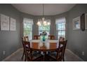Cozy dining room with a round wooden table and seating for six at 3332 Flagship Ave, Tavares, FL 32778