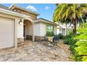 Front porch with stone flooring and seating area at 3428 Wentrop Ave, The Villages, FL 32163