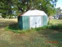 Green metal storage shed in backyard at 507 Barwick St, Wildwood, FL 34785