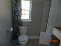 Simple bathroom with toilet and shower at 507 Barwick St, Wildwood, FL 34785