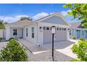 Well-maintained one-story house featuring gray garage door and small front yard at 5238 Dalessandro Rd, The Villages, FL 32163